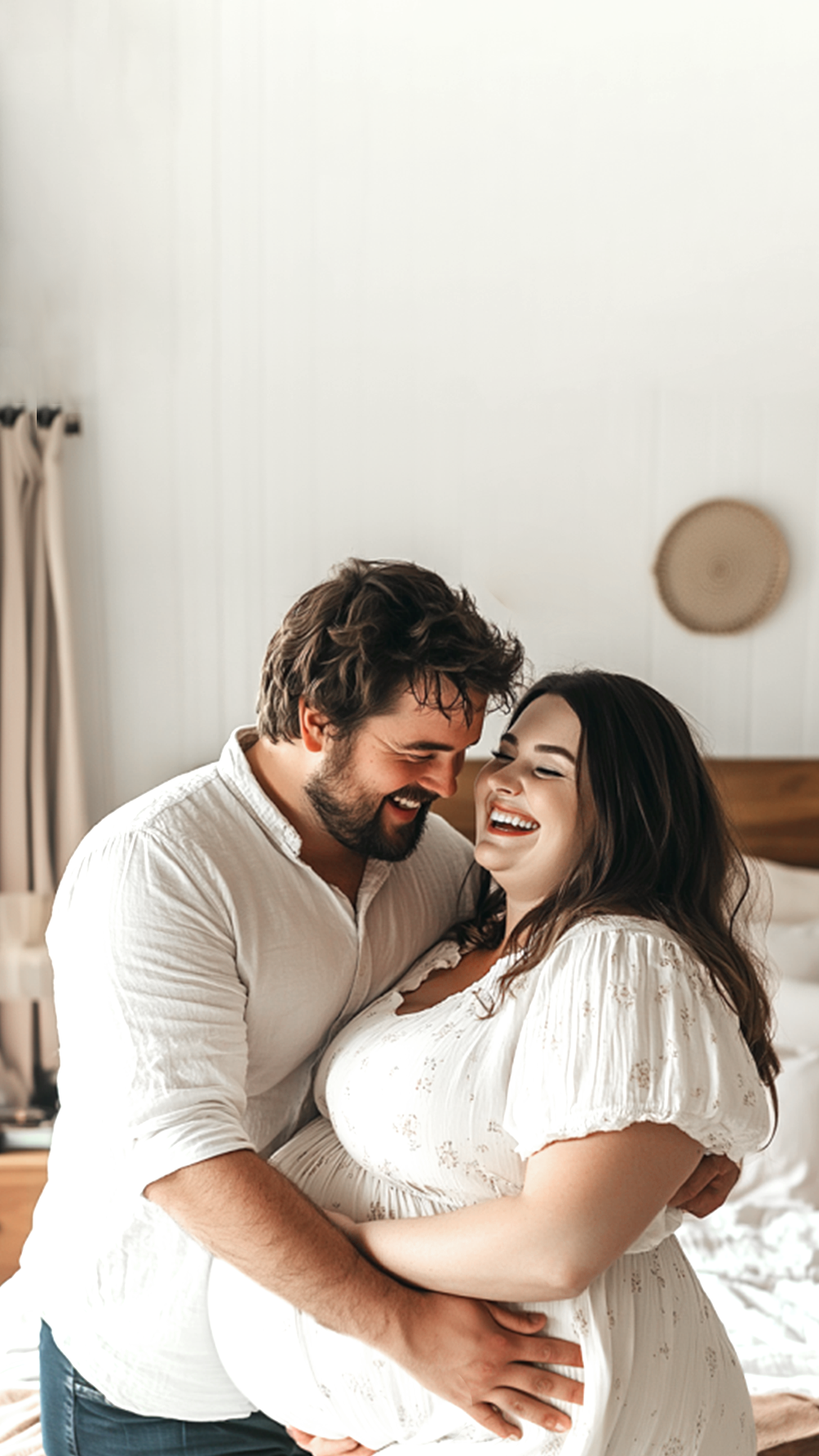 UK_mobile_banner_happy_pregnant_couple_in_their_bedroom_smiling_and_hugging_1.png